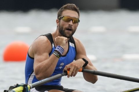 Stefanos Ntouskos of Greece reacts after winning the gold medal in the men's rowing single sculls final at the 2020 Summer Olympics, Friday, July 30, 2021, in Tokyo, Japan. (AP Photo/Darron Cummings)