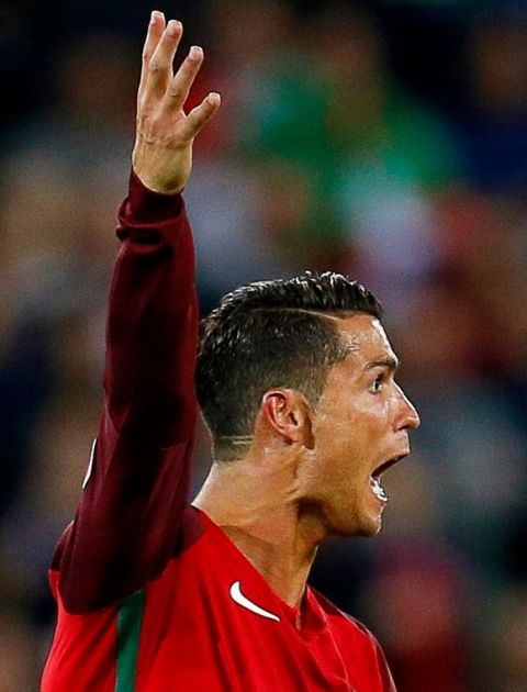 epa05365628 Cristiano Ronaldo of Portugal reacts during the UEFA EURO 2016 group F preliminary round match between Portugal and Iceland at Stade Geoffroy Guichard in Saint-Etienne, France, 14 June 2016. The match ended 1-1. (RESTRICTIONS APPLY: For editorial news reporting purposes only. Not used for commercial or marketing purposes without prior written approval of UEFA. Images must appear as still images and must not emulate match action video footage. Photographs published in online publications (whether via the Internet or otherwise) shall have an interval of at least 20 seconds between the posting.) EPA/ROBERT GHEMENT EDITORIAL USE ONLY