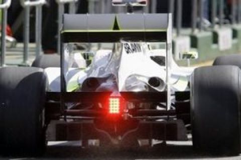 ** FILE ** In this March 27, 2009 file photo, Brawn GP Formula One driver Jenson Button of Britain, seen, leaving the pit showing the controversial diffuser during the first timed practice session at the Australian GP in Melbourne. Motor racing's governing body was meeting Tuesday, April 14, 2009 to decide on the legality of a car part that helped Brawn GP's Jenson Button win the season's opening two races. FIA officials went into closed-door hearings about the rear diffusers at its Paris headquarters, and were expected to hand down a ruling early Wednesday. (AP Photo/Rick Rycroft, File)