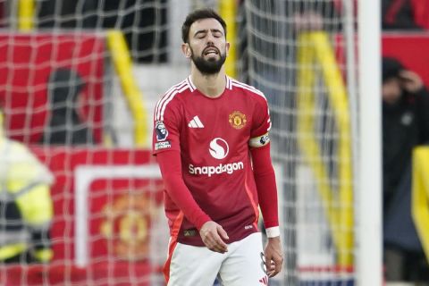 Manchester United's Bruno Fernandes is dejected after his team conceded the third goal during the English Premier League soccer match between Manchester United and Bournemouth at the Old Trafford stadium in Manchester, England, Sunday, Dec. 22, 2024. (AP Photo/Dave Thompson)