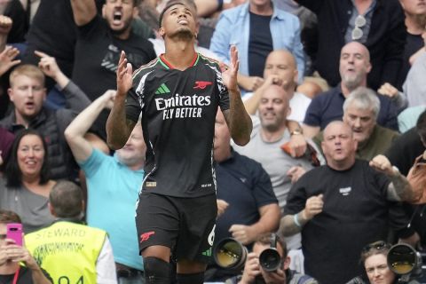 Arsenal's Gabriel celebrates after scoring the opening goal during the English Premier League soccer match between Tottenham Hotspur and Arsenal in London, Sunday, Sept. 15, 2024. (AP Photo/Kin Cheung)