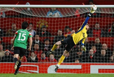 Manchester United's Dutch goalkeeper David de Gea (R) makes a save during the UEFA Europa League round of 16 first leg football match between Manchester United and Athletico Bilbao at Old Trafford in Manchester, north-west England on March 8, 2012. AFP PHOTO/ PAUL ELLIS (Photo credit should read PAUL ELLIS/AFP/Getty Images)