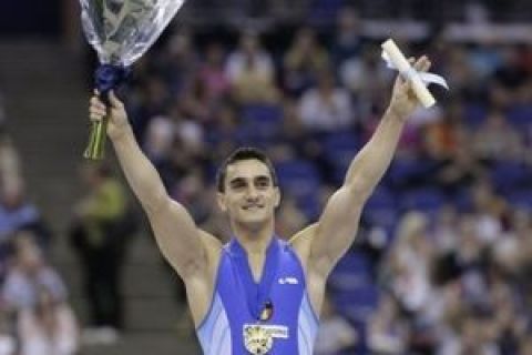 Marian Dragulescu of Romania stands on the podium with his gold medal in the men's vault final during the World Gymnastics Championships at the O2 Arena in London, Sunday, Oct. 18, 2009. (AP Photo/Matt Dunham)