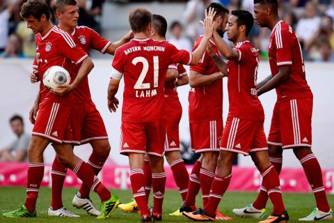 MOENCHENGLADBACH, GERMANY - JULY 21:  Thiago of FC Bayern Muenchen celebrates with teammates after scoring his team's third goal during the Telekom 2013 Cup final between FC Bayern Muenchen and Borussia Moenchengladbach on July 21, 2013 in Moenchengladbach, Germany.  (Photo by Dennis Grombkowski/Bongarts/Getty Images)