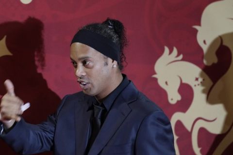 Brazilian soccer star and former FC Barcelona player Ronaldinho arrives for the the 2018 soccer World Cup draw in the Kremlin in Moscow, Friday, Dec. 1, 2017. (AP Photo/Dmitri Lovetsky)