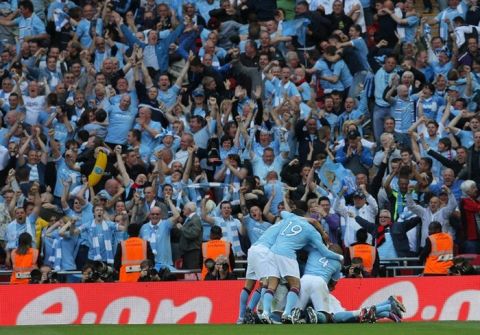 Manchester City players celebrate after their Ivorian footballer Yaya Toure scored against Stoke during the FA Cup final football match between Manchester City and Stoke City at Wembley Stadium in London, on May 14, 2011. AFP PHOTO / ADRIAN DENNIS
NOT FOR MARKETING OR ADVERTISING USE/RESTRICTED TO EDITORIAL USE (Photo credit should read ADRIAN DENNIS/AFP/Getty Images)