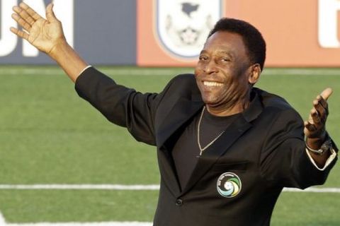 FILE - In this Aug. 3, 2013, file photo, Brazilian soccer legend Pele waves to the crowd during a pregrame cereomy before an NASL soccer game between the New York Cosmos and the Fort Lauderdale Strikers in Hempstead, N.Y.  Pele will watching, not playing, when two franchises that helped get soccer rolling in this country renew acquaintances. The Brazilian great's former team, the Cosmos, visit the Strikers on Saturday, rekindling memories of how more than 70,000 fans used to see them play. (AP Photo/Frank Franklin II, File)