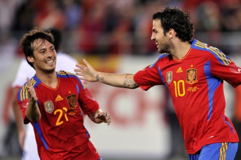 Spain's midfielder Cesc Fabregas (R) celebrates with teammate midfielder David Silva after scoring his team's second goal during a friendly football match Spain versus Chile on September 2, 2011 in at AFG Arena in St. Gallen.   AFP PHOTO / FABRICE COFFRINI (Photo credit should read FABRICE COFFRINI/AFP/Getty Images)