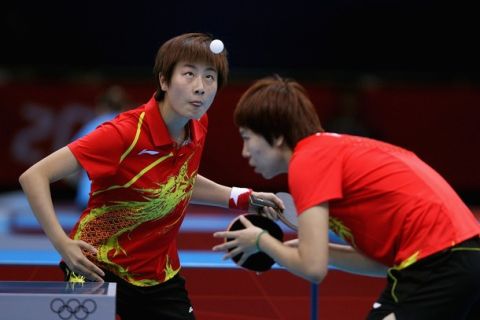 LONDON, ENGLAND - AUGUST 03:  Ning Ding and Xiaoxia Li of China complete during Women's Team Table Tennis first round match against team of Spain on Day 7 of the London 2012 Olympic Games at ExCeL on August 3, 2012 in London, England.  (Photo by Feng Li/Getty Images)