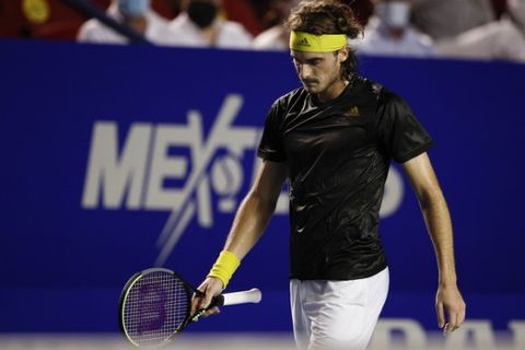 Greece's Stefanos Tsitsipas walks on the court between games as he plays against Germany's Alexander Zverev in the final match at the Mexican Open tennis tournament in Acapulco, Saturday, March 20, 2021. (AP Photo/Rebecca Blackwell)