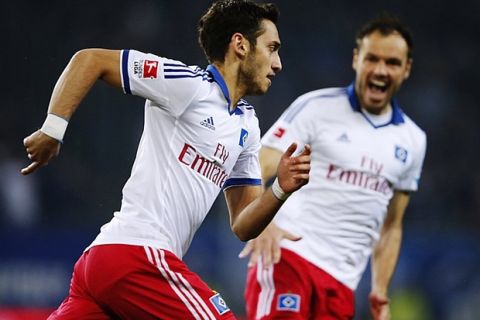 Hamburg's Turkish midfielder Hakan Calhanoglu (L) celebrates scoring during the German first division Bundesliga football match Hamburger SV vs Bayer Leverkusen in the northern German city of Hamburg on April 4, 2014. AFP PHOTO / OLIVER HARDT 

 RESTRICTIONS / EMBARGO - DFL LIMITS THE USE OF IMAGES ON THE INTERNET TO 15 PICTURES (NO VIDEO-LIKE SEQUENCES) DURING THE MATCH AND PROHIBITS MOBILE (MMS) USE DURING AND FOR FURTHER TWO HOURS AFTER THE MATCH. FOR MORE INFORMATION CONTACT DFL.        (Photo credit should read OLIVER HARDT/AFP/Getty Images)