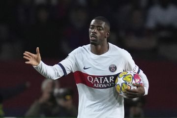 PSG's Ousmane Dembele celebrates after scoring his side's opening goal during the Champions League quarterfinal second leg soccer match between Barcelona and Paris Saint-Germain at the Olimpic Lluis Companys stadium in Barcelona, Spain, Tuesday, April 16, 2024. (AP Photo/Emilio Morenatti)