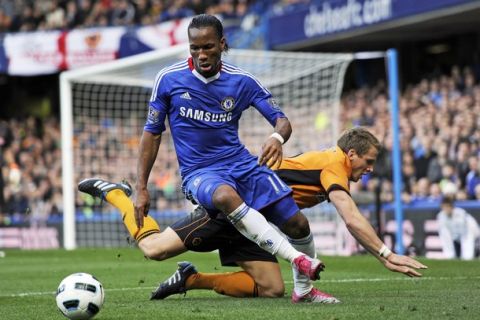 Chelsea's Ivorian striker Didier Drogba (L) vies with Wolverhampton Wanderers' Scottish defender Christophe Berra (R) during the English Premier League football match between Chelsea and Wolverhampton Wanderers at Stamford Bridge in London, England on October 23, 2010. AFP PHOTO/GLYN KIRK  FOR EDITORIAL USE ONLY Additional licence required for any commercial/promotional use or use on TV or internet (except identical online version of newspaper) of Premier League/Football League photos. Tel DataCo +44 207 2981656. Do not alter/modify photo. (Photo credit should read GLYN KIRK/AFP/Getty Images)