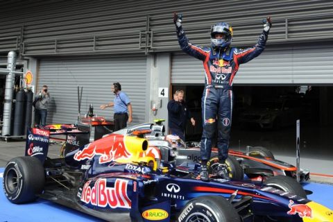 Red Bull Racing's German driver Sebastian Vettel celebrates in the parc ferme at the Spa-Francorchamps circuit on August 28, 2011 in Spa after the Belgium Formula One Grand Prix.   AFP PHOTO/ TOM GANDOLFINI (Photo credit should read Tom Gandolfini/AFP/Getty Images)