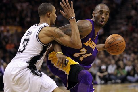 SAN ANTONIO, TX - DECEMBER 28:  Guard Kobe Bryant #24 of the Los Angeles Lakers dribbles the ball against George Hill #3 of the San Antonio Spurs at AT&T Center on December 28, 2010 in San Antonio, Texas.  NOTE TO USER: User expressly acknowledges and agrees that, by downloading and/or using this photograph, user is consenting to the terms and conditions of the Getty Images License Agreement.  (Photo by Ronald Martinez/Getty Images)