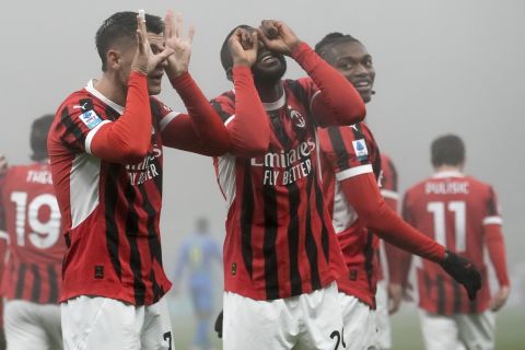 AC Milan's Alvaro Morata, left, celebrates with his teammate Youssouf Fofana as Rafa Leao, right, looks on, after scoring his side's opening goal during the Italian Serie A soccer match between AC Milan and Empoli, at the Milan San Siro stadium, Italy, Saturday, Nov. 30, 2024. (AP Photo/Luca Bruno)