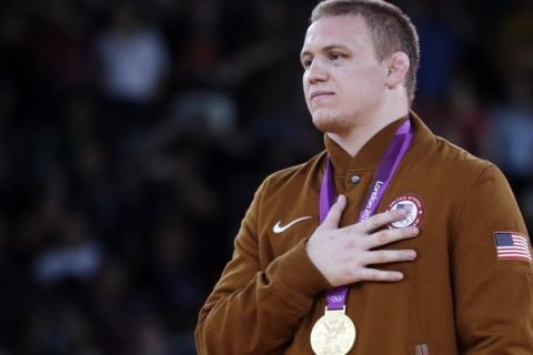 Gold medalist Jacob Stephen Varner of the United States, participates in the medals ceremony for men's 96-kg freestyle wrestling at the 2012 Summer Olympics, Sunday, Aug. 12, 2012, in London. (AP Photo/Paul Sancya)