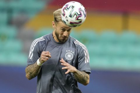 Germany's Niklas Dorsch heads the ball during the warm-up before the Euro U21 final soccer match between Germany and Portugal at the Stozice stadium in Ljubljana, Slovenia, Sunday, June 6, 2021. (AP Photo/Darko Bandic)