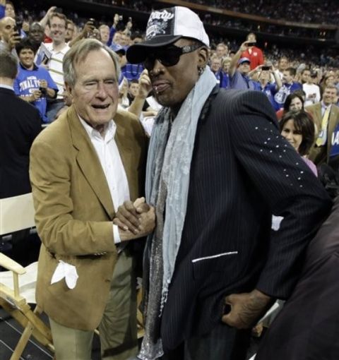 Former NBA player Dennis Rodman greets former President George H. Bush during halftime of the men's NCAA Final Four college basketball championship game between Butler and Connecticut Monday, April 4, 2011, in Houston. (AP Photo/David J. Phillip)