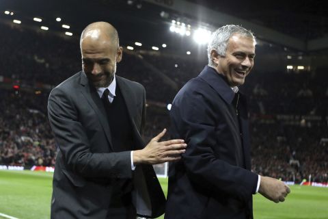 Manchester City's manager Pep Guardiola, left, and Manchester United's manager Jose Mourinho smile ahead of the English League Cup soccer match between Manchester United and Manchester City at Old Trafford stadium in Manchester, Wednesday, Oct. 26, 2016. (AP Photo/Dave Thompson)