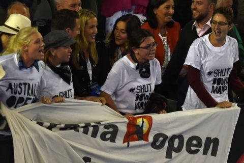 Protestors shout slogans from the stands as Serbia's Novak Djokovic plays during his men's singles final match against Britain's Andy Murray on day fourteen of the 2015 Australian Open tennis tournament in Melbourne on February 1, 2015. AFP PHOTO / MANAN VATSYAYANA -- IMAGE RESTRICTED TO EDITORIAL USE - STRICTLY NO COMMERCIAL USEMANAN VATSYAYANA/AFP/Getty Images ORIG FILE ID: 537359498