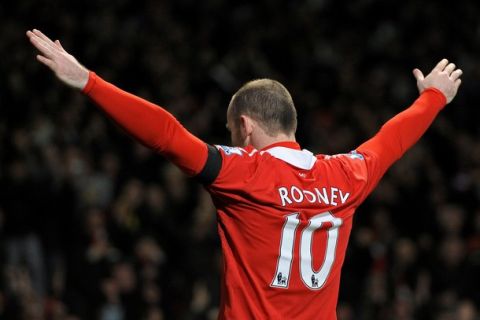 Manchester United's English striker Wayne Rooney celebrates after scoring the opening goal of the English Premier League football match between Manchester United and Aston Villa at Old Trafford in Manchester, north-west England on February 1, 2011. AFP PHOTO/ANDREW YATESRESTRICTED TO EDITORIAL USE Additional licence required for any commercial/promotional use or use on TV or internet (except identical online version of newspaper) of Premier League/Football League photos. Tel DataCo +44 207 2981656. Do not alter/modify photo (Photo credit should read ANDREW YATES/AFP/Getty Images)