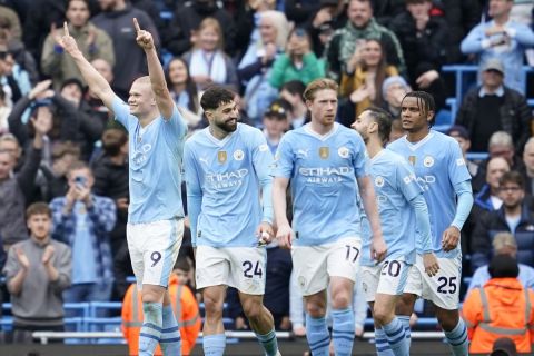 Manchester City's Erling Haaland, left, celebrates after scoring his side's third goal during the English Premier League soccer match between Manchester City and Wolverhampton Wanderers at the Etihad Stadium in Manchester, England, Saturday, May 4, 2024. (AP Photo/Dave Thompson)