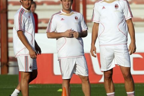 Controversial Italian forward Antonio Cassano (C) stands with Zlatan Ibrahimovic (R) and Pato train at the grounds of Al-Ahli Stadium in Dubai on December 28, 2010 during the annual winter training camp of AC Milan in the Gulf emirate which will culminate in the Emirates Challenge Cup match against Al-Ahli club on January 2. Cassano has reached agreement to join AC Milan after falling out of favour at Sampdoria, but the contract will not be filed before the official opening of the transfer market on January 2.  AFP PHOTO/MARWAN NAAMANI (Photo credit should read MARWAN NAAMANI/AFP/Getty Images)