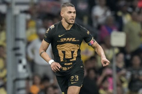 Pumas' Nicolas Freire runs with the ball during a Mexican soccer league match against America at Azteca stadium in Mexico City, Saturday, April 22, 2023. (AP Photo/Moises Castillo)