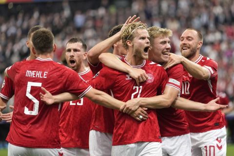 Denmark's Morten Hjulmand, center, celebrates with teammates after scoring his sides first goal during a Group C match between Denmark and England at the Euro 2024 soccer tournament in Frankfurt, Germany, Thursday, June 20, 2024. (AP Photo/Sergei Grits)