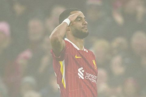 Liverpool's Cody Gakpo celebrates after scoring his side's first goal against Leicester City during the English Premier League soccer match at the Anfield stadium in Liverpool, Thursday, Dec. 26, 2024. (AP Photo/Ian Hodgson)