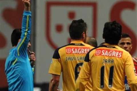 Benfica's Javi Garcia, center, from Spain is shown a red card by referee Carlos Xistra during their Portuguese League soccer match against Sporting Braga at the Municipal Stadium in Braga, Portugal, Sunday, March 6, 2011. (AP Photo/Paulo Duarte)