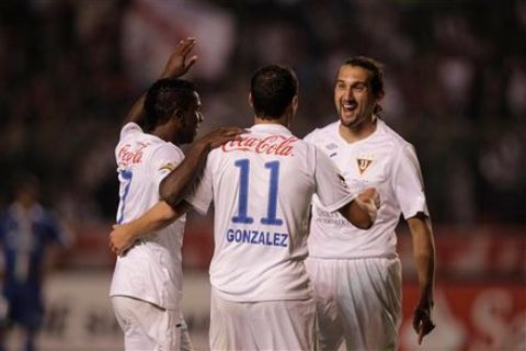 Ecuador's Liga Deportiva Universitaria's Ezequiel Gonzalez  11, celebrates after scoring against Argentina's Velez Sarsfield during a Copa Sudamericana semifinal soccer match in Quito, Ecuador, Thursday, Nov. 24, 2011. (AP Photo/Dolores Ochoa)