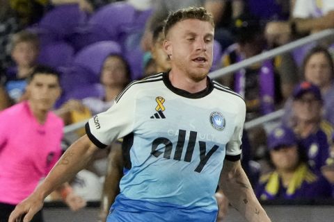 Orlando City's Iván Angulo, right, moves the ball past Charlotte FC's Pep Biel (10) during the first half of an MLS soccer match, Wednesday, Sept. 18, 2024, in Orlando, Fla. (AP Photo/John Raoux)