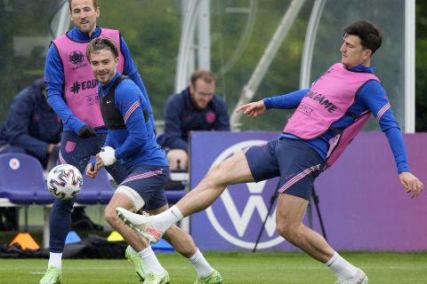 England's Harry Kane,left, and England's Jack Grealish and England's Harry Maguire, right, challenge for the ball during a team training session at Tottenham Hotspur training ground in London, Monday, June 21, 2021 one day ahead of the Euro 2020 soccer championship group D match against Czech Republic. (AP Photo/Frank Augstein)