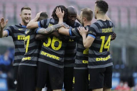 Inter Milan's Matteo Darmian, left, celebrates with his teammate Inter Milan's Romelu Lukaku after scoring his side's second goal during a Serie A soccer match between Inter Milan and Genoa at the San Siro stadium in Milan, Italy, Sunday, Feb. 28, 2021. (AP Photo/Luca Bruno)