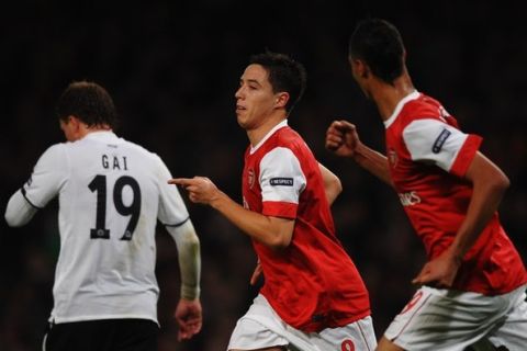 LONDON, ENGLAND - OCTOBER 19:  Samir Nasri of Arsenal (C) celebrates with team mate Marouane Chamakh (R) as he scores their second goal during the UEFA Champions League Group H match between Arsenal and FC Shakhtar Donetsk at the Emirates Stadium on October 19, 2010 in London, England.  (Photo by Laurence Griffiths/Getty Images)