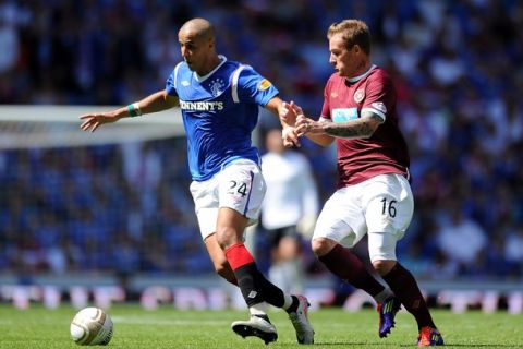 GLASGOW, SCOTLAND - JULY 23:  Madjid Bougherra of Rangers competes with Ryan Stevenson of Hearts during the Clydesdale Bank Premier League match between Rangers and Hearts at Ibrox Stadium on July 23, 2011 in Glasgow, Scotland.  (Photo by Chris Brunskill/Getty Images)