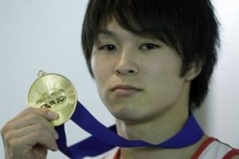 Kohei Uchimura of Japan poses with his gold medal after winning the World Gymnastics Championships Men's all-around final at the O2 Arena in London, Thursday, Oct. 15, 2009. (AP Photo/Matt Dunham)