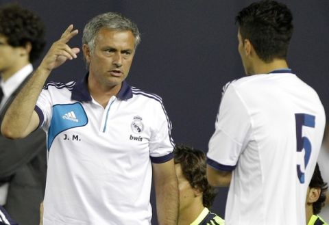 Real Madrid manager Jose Mourinho, left, gestures to midfielder Nuri Sahin (5) on the sideline during the second half of their exhibition soccer match against A.C. Milan at Yankee Stadium in New York, Wednesday, Aug. 8, 2012.  Real Madrid defeated A.C. Milan 5-1. (AP Photo/Kathy Willens)