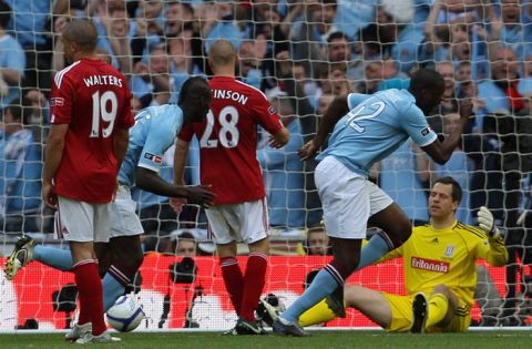 Manchester City's Ivorian footballer Yaya Toure (2nd R) wheels away in celebration after scoring against Stoke during the FA Cup final football match between Manchester City and Stoke City at Wembley Stadium in London, on May 14, 2011. AFP PHOTO / ADRIAN DENNIS
NOT FOR MARKETING OR ADVERTISING USE/RESTRICTED TO EDITORIAL USE (Photo credit should read ADRIAN DENNIS/AFP/Getty Images)