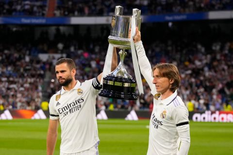 Real Madrid's Nacho, left, and Luka Modric hold up the Copa del Rey trophy prior to a Spanish La Liga soccer match between Real Madrid and Getafe at the Santiago Bernabeu stadium in Madrid, Spain, Saturday, May 13, 2023. (AP Photo/Manu Fernandez)