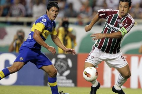 Fred (R) of Brazil's Fluminense challenges Fecundo Roncaglia of Argentina's Boca Juniors during their Copa Libertadores soccer match at the Joao Havelange stadium in Rio de Janeiro April 11, 2012.. REUTERS/Sergio Moraes (BRAZIL - Tags: SPORT SOCCER)