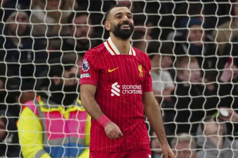 Liverpool's Mohamed Salah celebrates after scoring his side's fourth goal during the English Premier League soccer match between Tottenham and Liverpool at Tottenham Hotspur Stadium in London, Sunday, Dec. 22, 2024. (AP Photo/Dave Shopland)