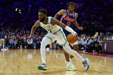 Boston Celtics' Jaylen Brown gets past Philadelphia 76ers' Tyrese Maxey during the second half of an NBA basketball game, Tuesday, Feb. 15, 2022, in Philadelphia. The Celtics won 135-87. (AP Photo/Chris Szagola)