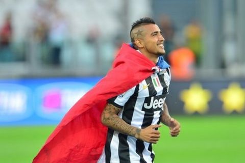 Juventus' midfielder of Chile Arturo Vidal arrives on the pitch for the ceremony of the Scudetto, the Italian Serie A trophy after the Italian Serie A football match between Juventus and Cagliari at the "Juventus Stadium" in Turin on May 11, 2013. Juventus cemented a 29th title triumph a week before after another near flawless campaign, but for coach Antonio Conte hoisting the club back among the giants of European football will continue to be hampered by a cash-strapped Serie A. AFP PHOTO / GIUSEPPE CACACE        (Photo credit should read GIUSEPPE CACACE,GIUSEPPE CACACE/AFP/Getty Images)