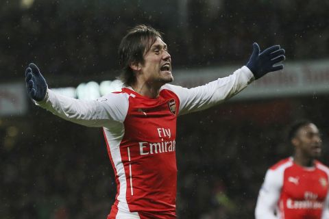 FILE - A Friday, Dec. 26, 2014 file photo of Arsenal's Tomas Rosicky celebrating after scoring a goal during the English Premier League soccer match between Arsenal and Queens Park Rangers at the Emirates Stadium, London. Rosicky has undergone an Achilles tendon injury and and wont be available to play till the rest of the season. The 36-year-old Rosicky signed a two-year contract with Sparta Prague in August, but played for only some 19 minutes as a substitute in a league game on Sept. 10 and has not been on the bench since. (AP Photo/Tim Ireland, File)