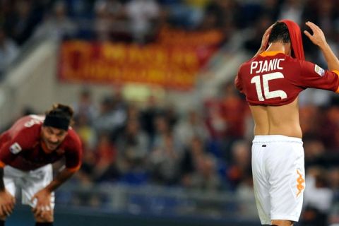 AS Roma's midfielder of Bosnia-Herzegovina Miralem Pjanic reacts during their Serie A football match AS Roma vs Siena at the Olympic stadium in Rome on September 22, 2011.    AFP PHOTO/ TIZIANA FABI (Photo credit should read TIZIANA FABI/AFP/Getty Images)