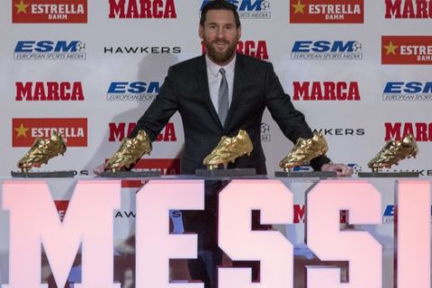 FC Barcelona's Lionel Messi from Argentina poses for the media after receiving his 5th Golden Boot award, in Barcelona, Spain, Tuesday, Dec.18, 2018. (AP Photo/Joan Monfort)