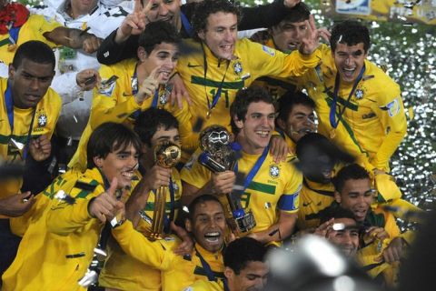 Brazilian players celebrate with the trophy after beating Portugal in the FIFA 2011 Under-20 World Cup final match in Bogota on August 20, 2011. Brazil won 3-2 in overtime.  AFP PHOTO / EITAN ABRAMOVICH (Photo credit should read EITAN ABRAMOVICH/AFP/Getty Images)